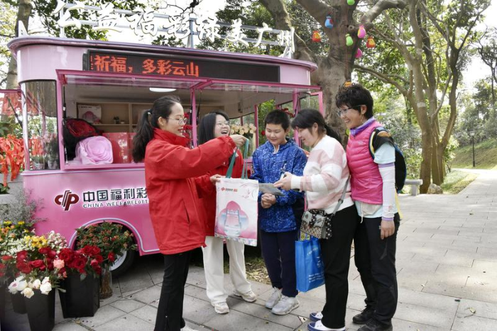 工作人员向市民游客宣传介绍福彩