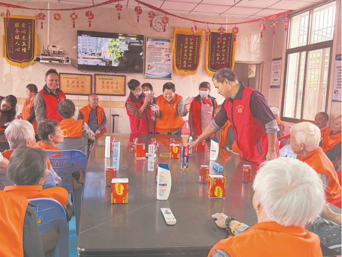 老人在梧塘镇敬老院活动室里玩套圈游戏乐不停。